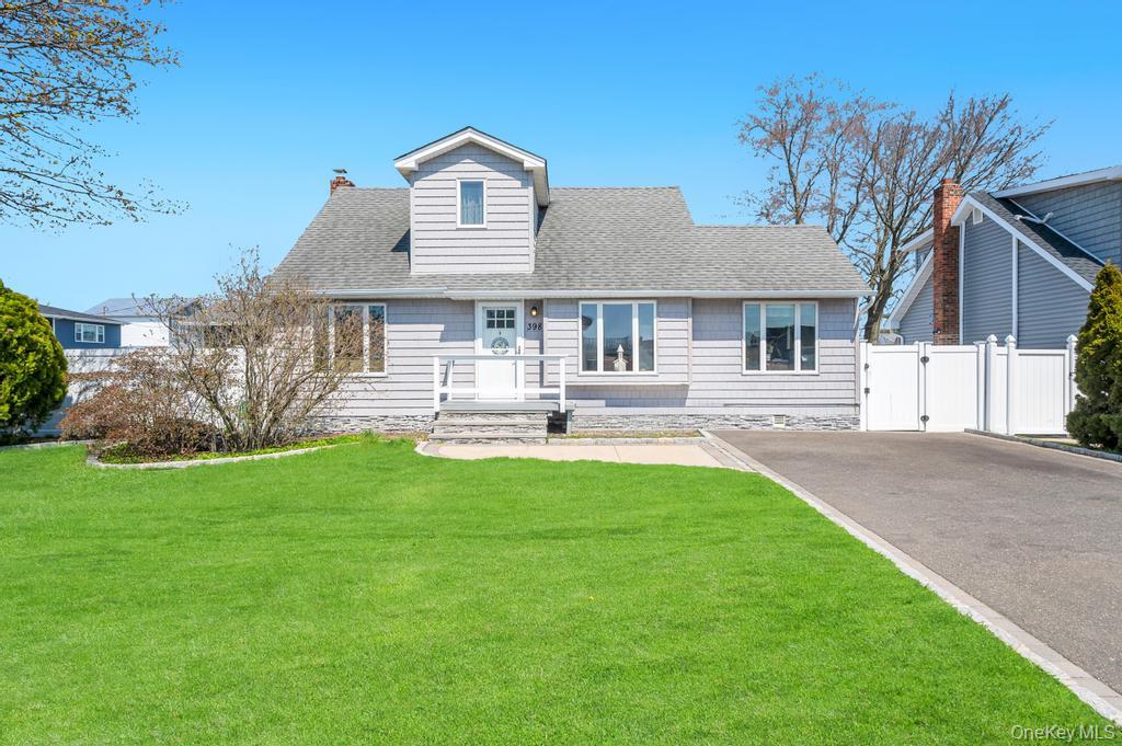 398 33rd Street Lindenhurst, NY 11757 - Photo 3 of 44 a front view of a house with a yard