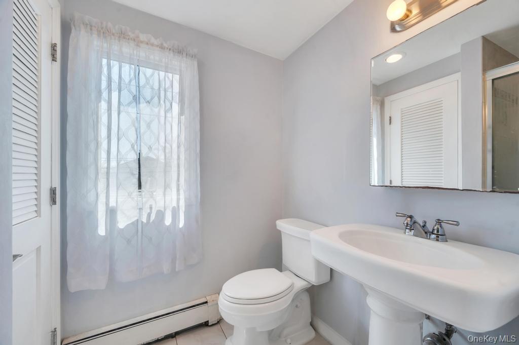 398 33rd Street Lindenhurst, NY 11757 - Photo 31 of 44 a bathroom with a sink toilet and a mirror