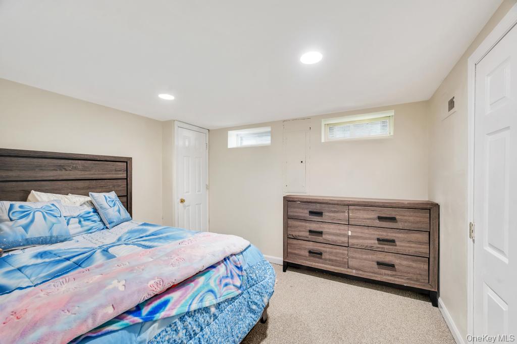 398 33rd Street Lindenhurst, NY 11757 - Photo 35 of 44 a bedroom with a bed and a dresser