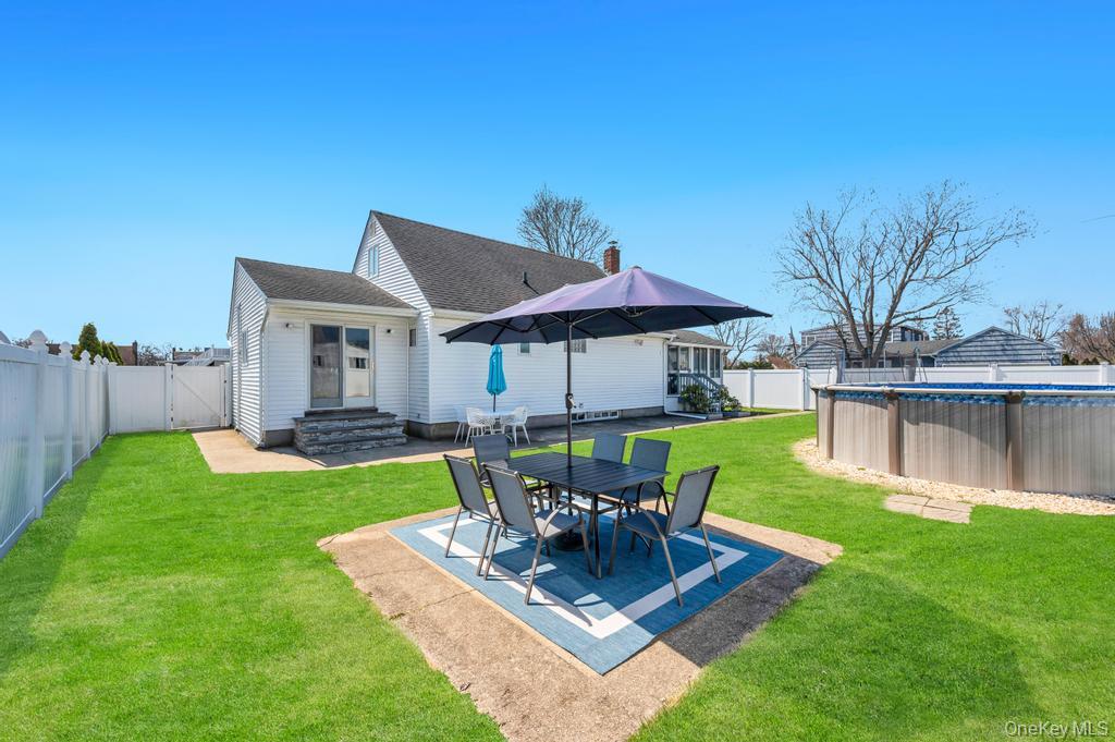 398 33rd Street Lindenhurst, NY 11757 - Photo 6 of 44 a view of a house with backyard sitting area and garden