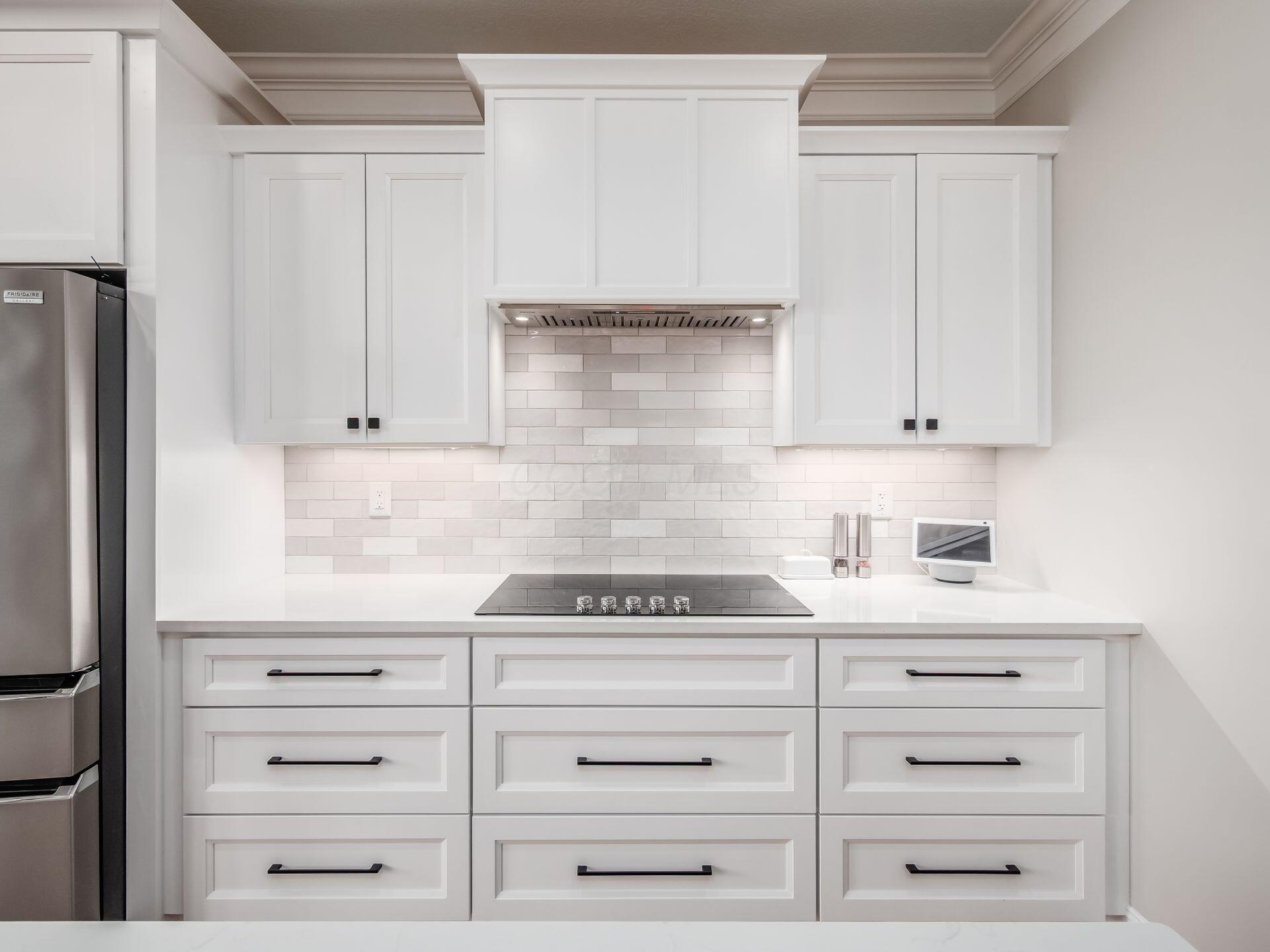 357 Tipperary Loop Delaware, OH 43015 - Photo 21 of 71 Custom hood, electric cooktop and sleek tile backsplash