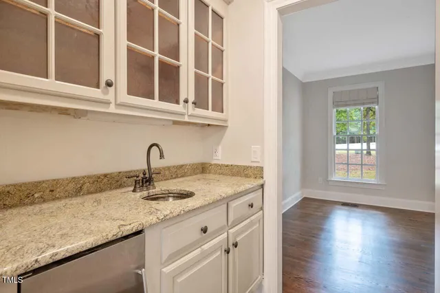 a kitchen with granite countertop stainless steel appliances sink and cabinets