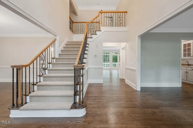 a view of entryway and hall with wooden floor