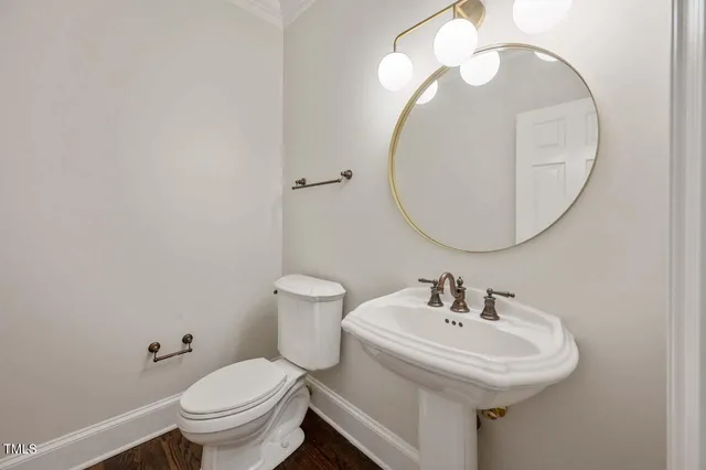 a bathroom with a sink a mirror and a toilet