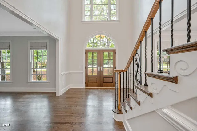 an entryway with wooden floor and door