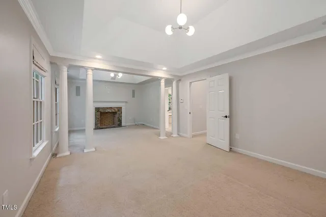 a view of empty room with a fireplace and fan