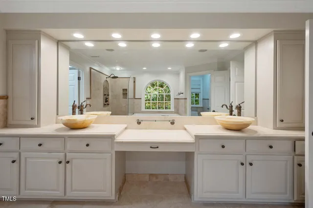 a large kitchen with kitchen island a sink stainless steel appliances and cabinets
