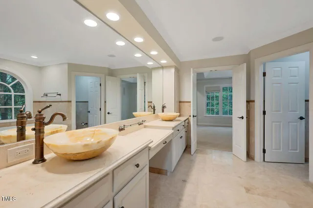 a large white kitchen with a large window