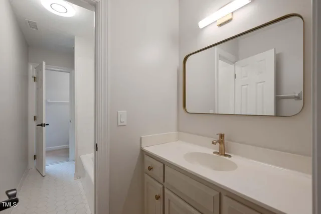 a bathroom with a sink and mirror