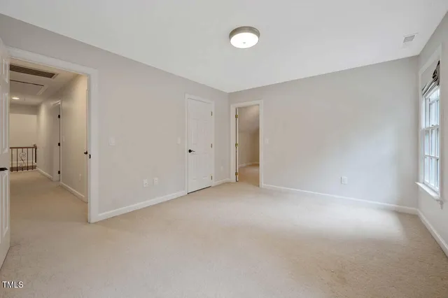an empty room with a bathroom and a sink