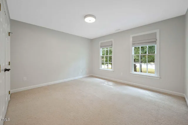 a bathroom with a toilet a sink a tub and mirror