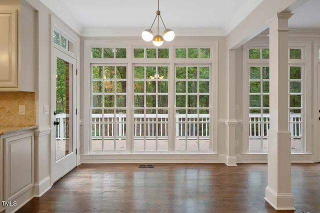 a view of an entryway with wooden floor and windows