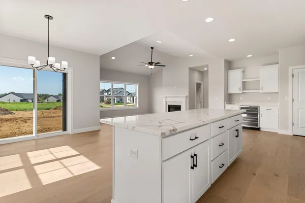 a living room with furniture a flat screen tv and a large window