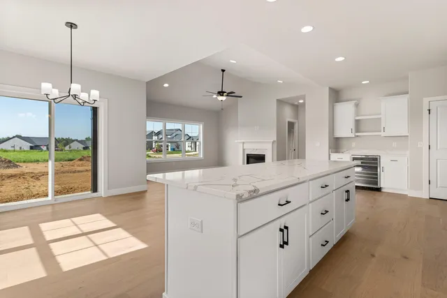 a living room with furniture a flat screen tv and a large window