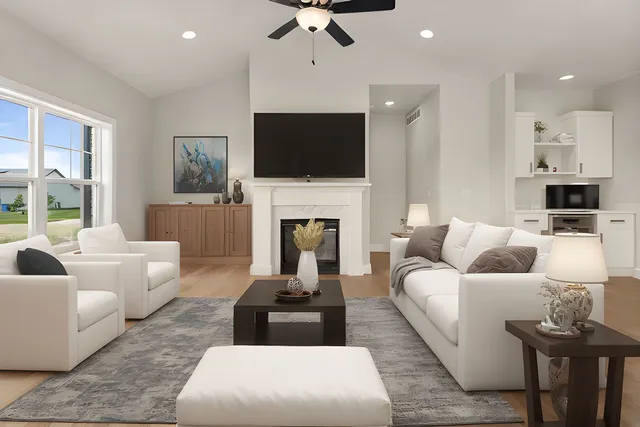 a view of empty room with a fireplace and wooden floor