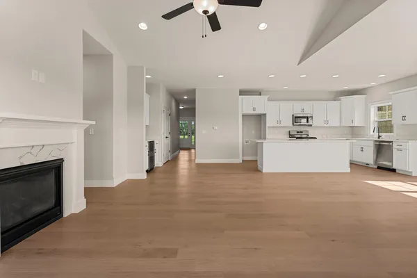 a living room with furniture and kitchen view