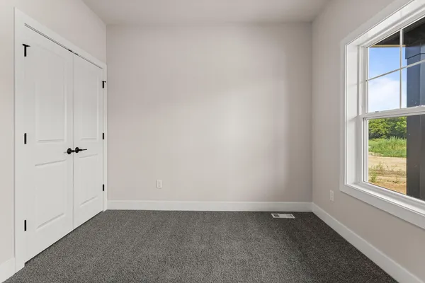 a room with window and a rug