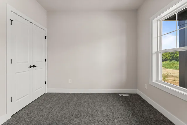 a room with window and a rug