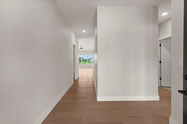 a view of a hallway with wooden floor