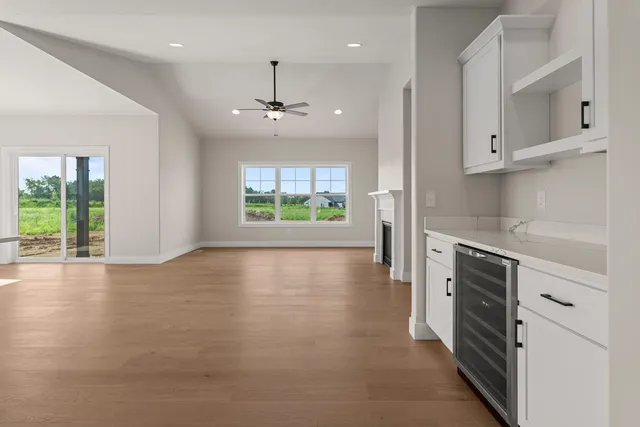 an empty room with windows and cabinet