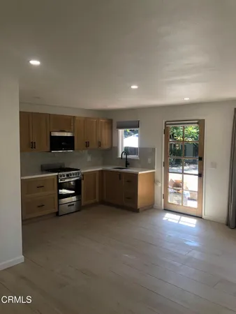 a kitchen with stainless steel appliances granite countertop a sink and a stove