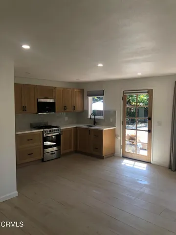 a kitchen with stainless steel appliances granite countertop a sink and a stove