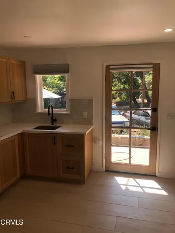 a kitchen with granite countertop a stove and a microwave