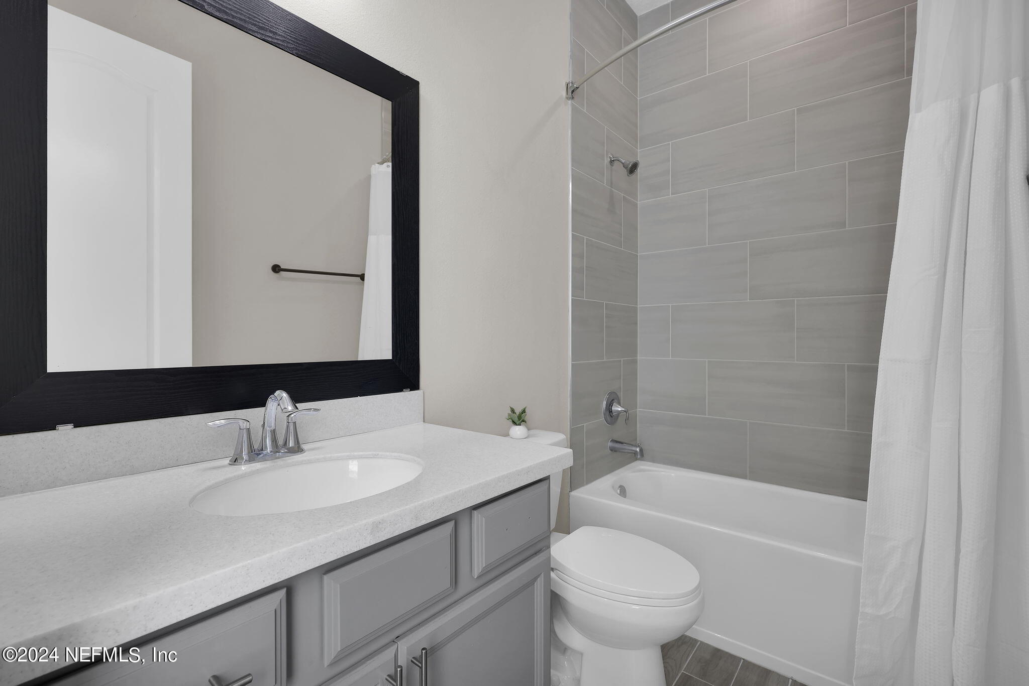 100 Calliel Way St. Johns, FL 32259 - Photo 19 of 50 a bathroom with a granite countertop sink a toilet and a mirror