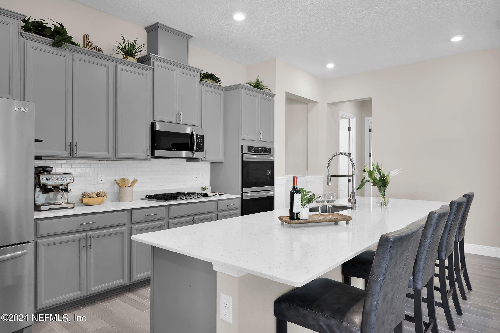 100 Calliel Way St. Johns, FL 32259 - Photo 5 of 50 a kitchen with stainless steel appliances a white table chairs and a refrigerator