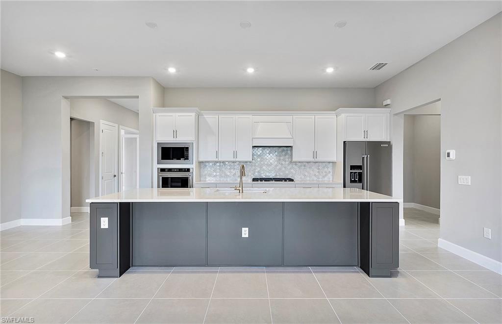 20039 Nickel Trail Alva, FL 33920 - Photo 11 of 50 a large kitchen with stainless steel appliances lots of counter top space and cabinets