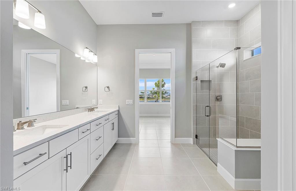 20039 Nickel Trail Alva, FL 33920 - Photo 15 of 50 a spacious bathroom with a shower tub double and mirror
