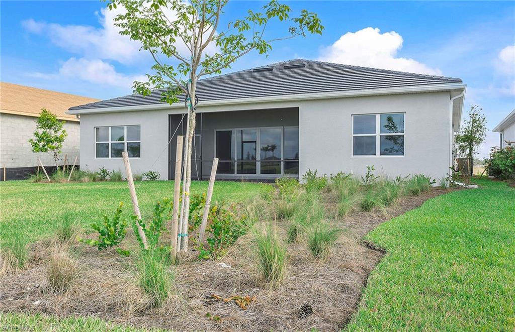 20039 Nickel Trail Alva, FL 33920 - Photo 25 of 50 a view of a house with yard and a garden