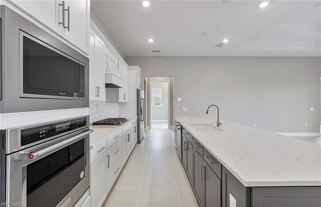 20039 Nickel Trail Alva, FL 33920 - Photo 9 of 50 a kitchen with stainless steel appliances a sink stove and cabinets