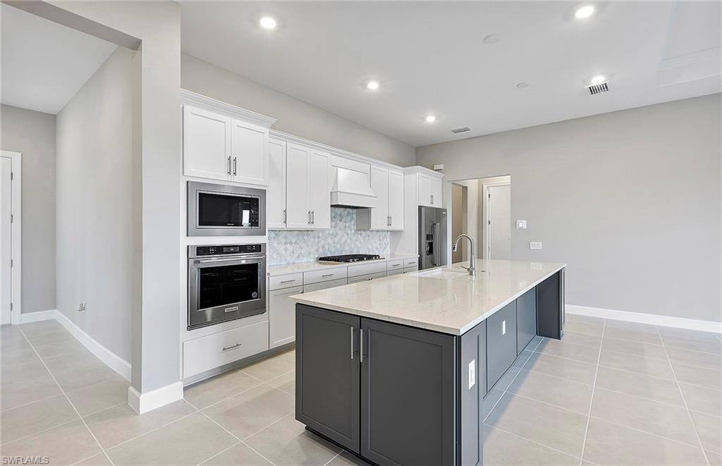 20039 Nickel Trail Alva, FL 33920 - Photo 10 of 50 a kitchen with a sink stove top oven and cabinets