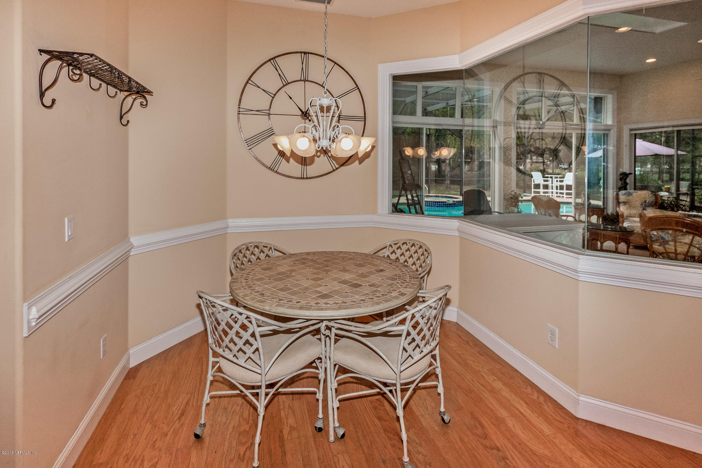 3357 Kings Road South St. Augustine, FL 32086 - Photo 13 of 31 a view of a dining room with furniture a chandelier and wooden floor
