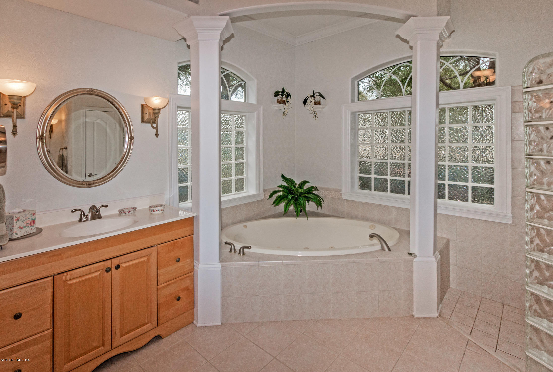 3357 Kings Road South St. Augustine, FL 32086 - Photo 17 of 31 a bathroom with a sink a bathtub and a mirror