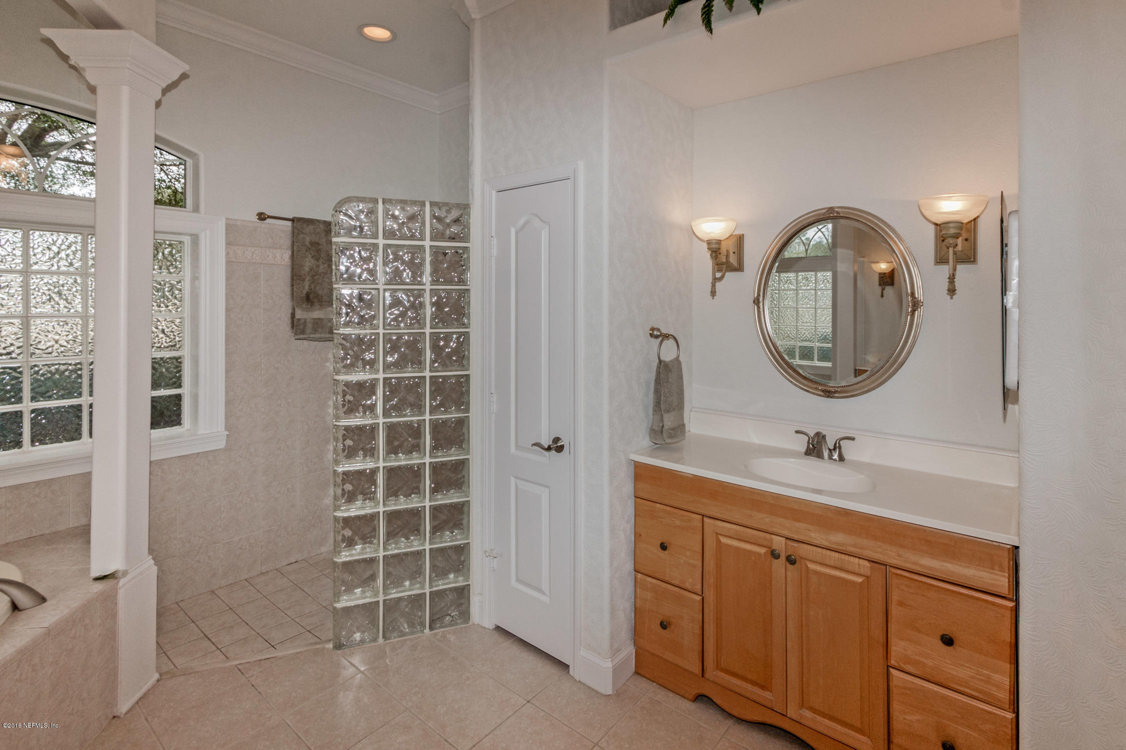 3357 Kings Road South St. Augustine, FL 32086 - Photo 18 of 31 a bathroom with a double vanity sink and a mirror