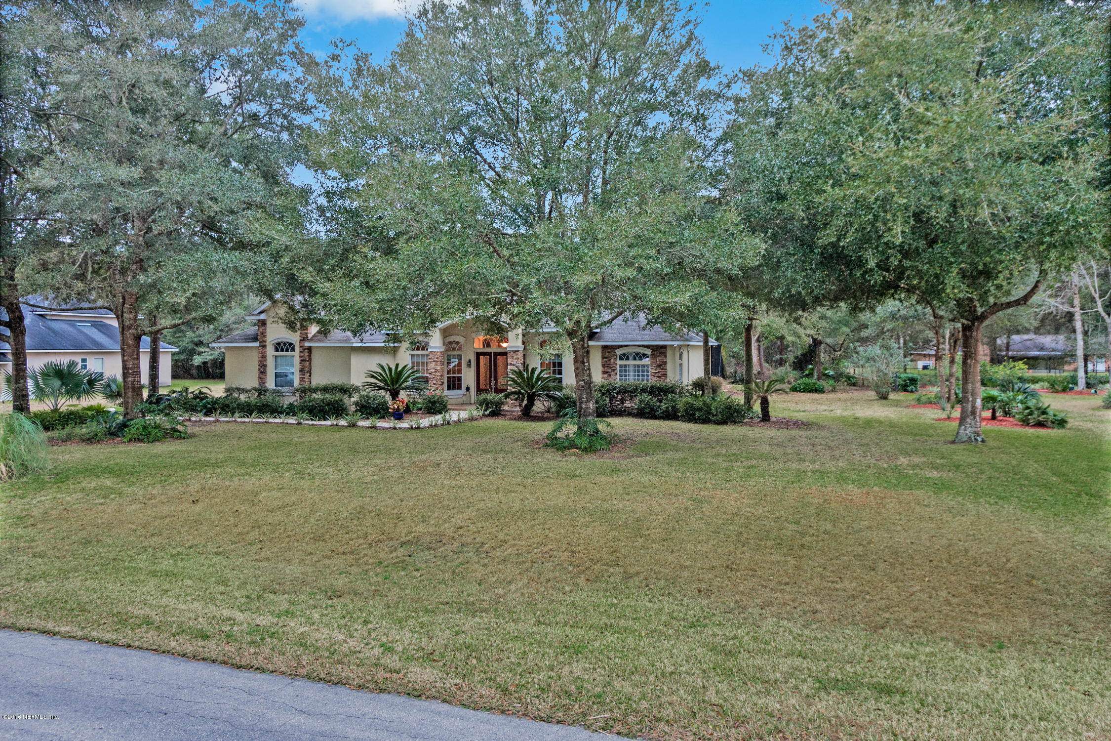 3357 Kings Road South St. Augustine, FL 32086 - Photo 2 of 31 a front view of a house with a garden