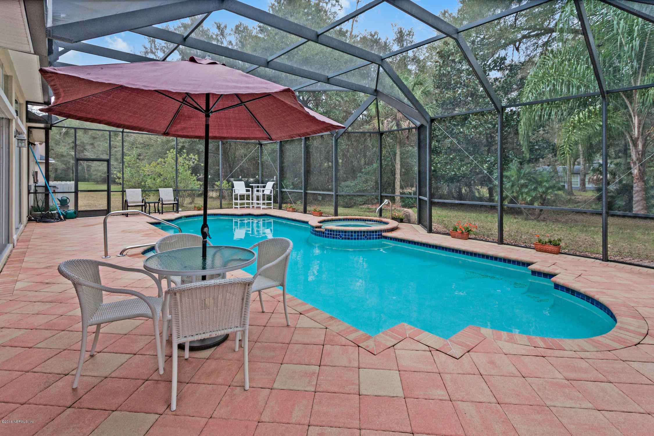 3357 Kings Road South St. Augustine, FL 32086 - Photo 29 of 31 a view of pool with table and chairs under an umbrella