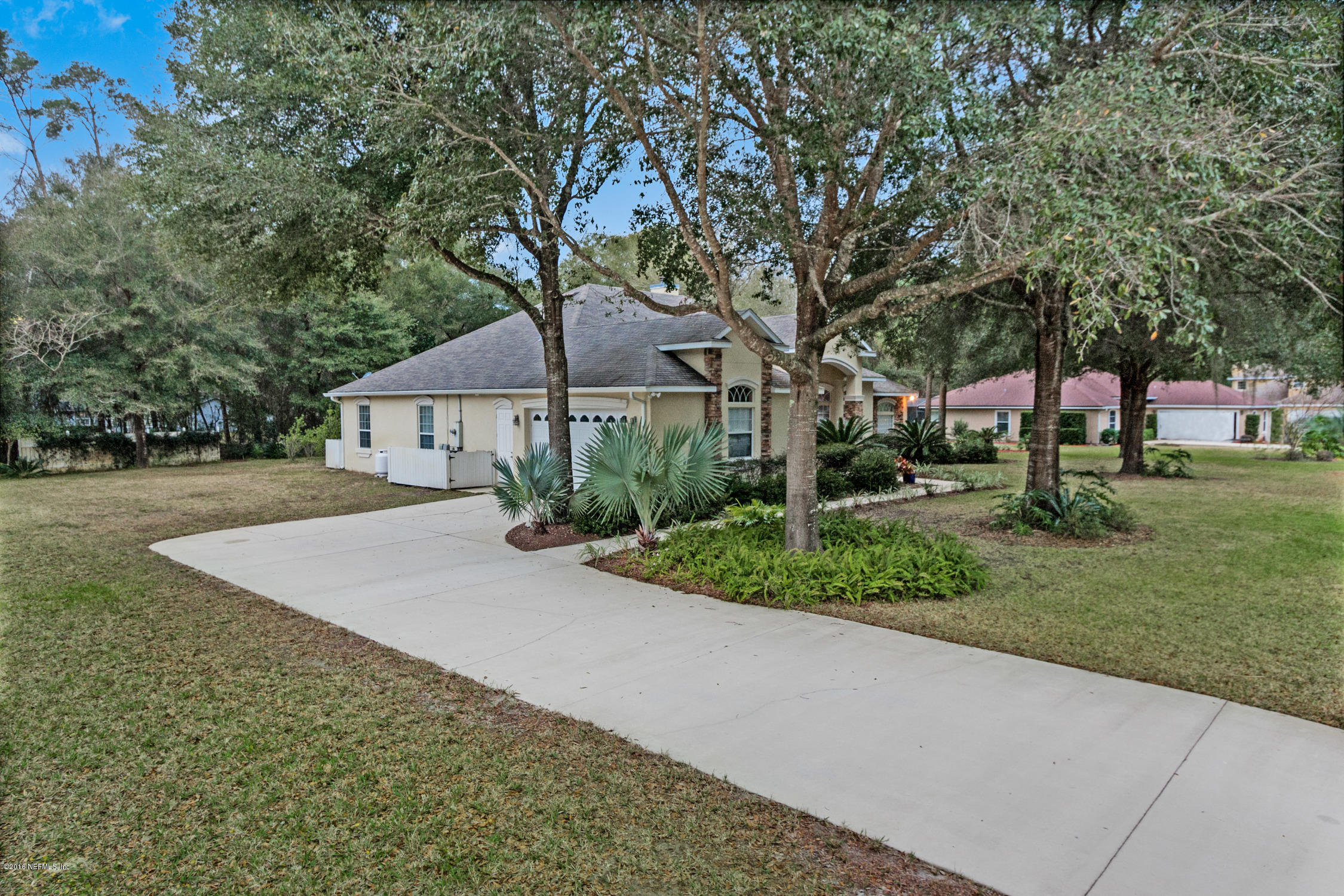 3357 Kings Road South St. Augustine, FL 32086 - Photo 3 of 31 a front view of a house with a yard and trees