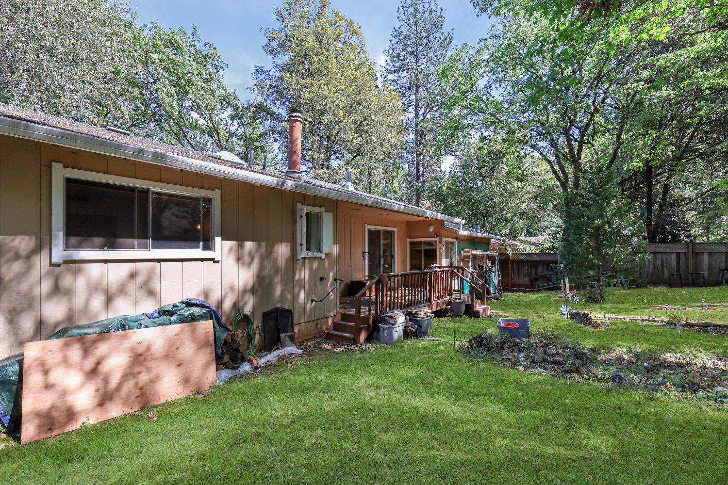 19688 Murphy Road Pine Grove, CA 95665 - Photo 8 of 8 a backyard of a house with barbeque oven and outdoor seating