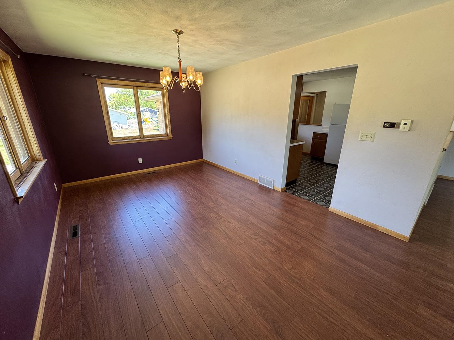 401 South Ridge Street Shannon, IL 61078 - Photo 12 of 40 a view of an empty room with wooden floor and a window