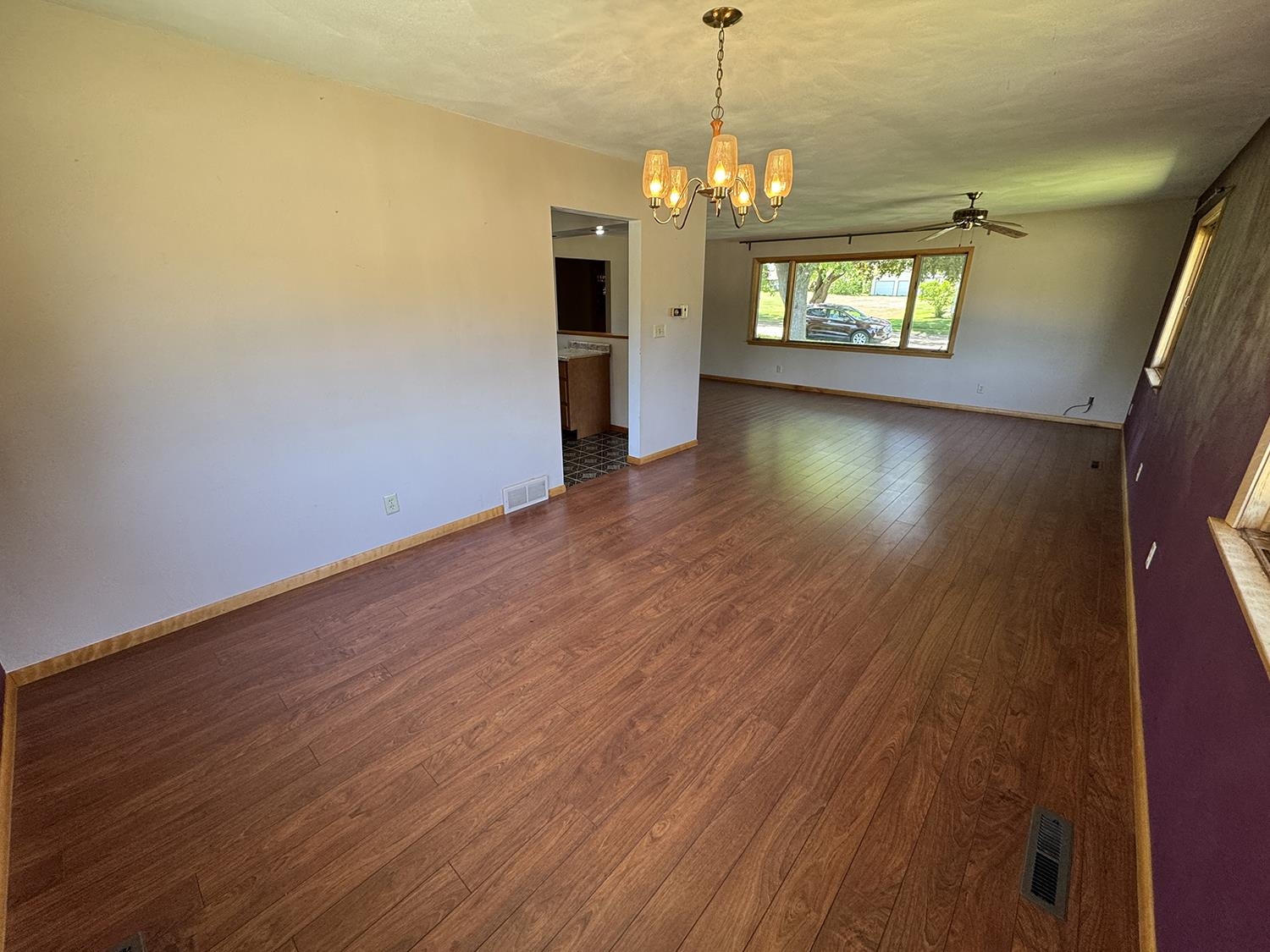 401 South Ridge Street Shannon, IL 61078 - Photo 15 of 40 an empty room with wooden floor and windows