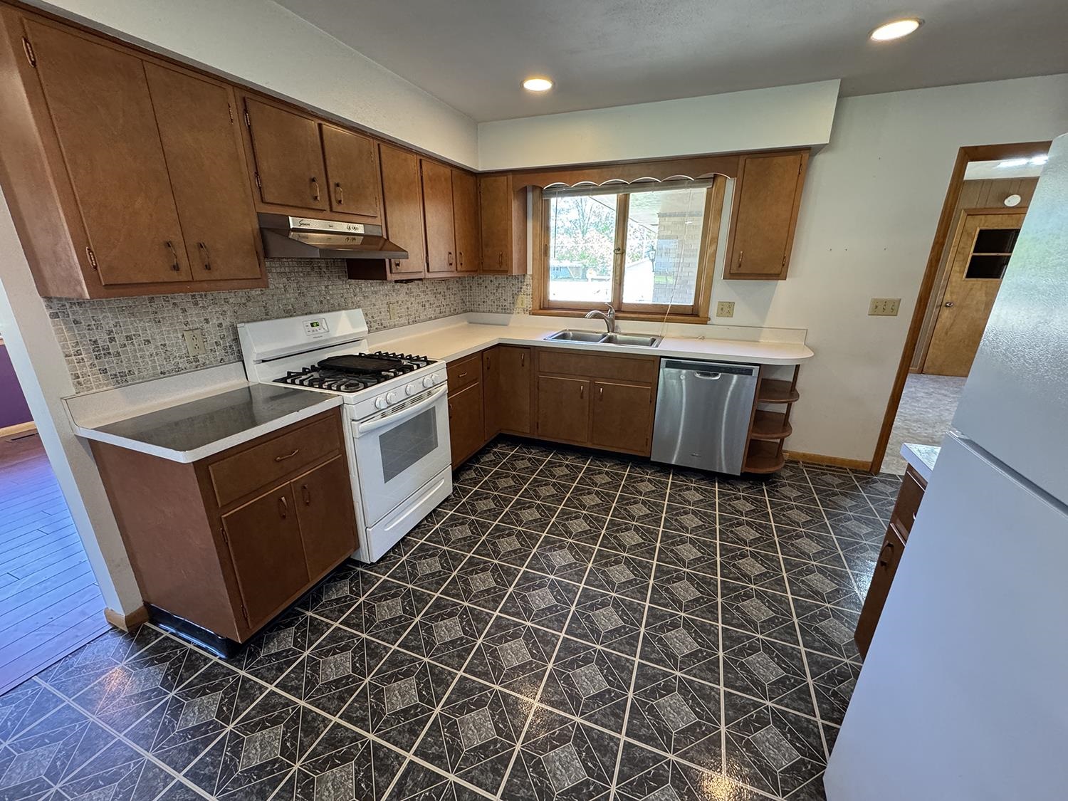 401 South Ridge Street Shannon, IL 61078 - Photo 17 of 40 a kitchen with a sink a stove a microwave and cabinets