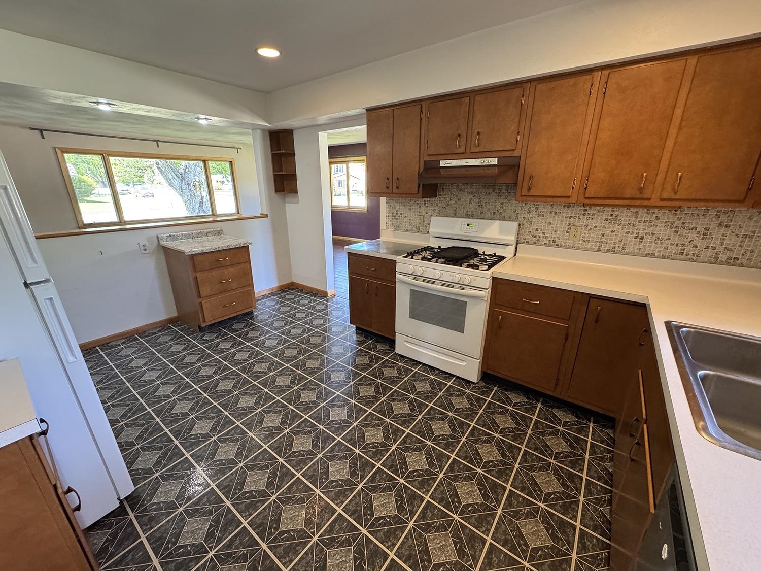 401 South Ridge Street Shannon, IL 61078 - Photo 19 of 40 a kitchen with stainless steel appliances a stove a sink and a microwave