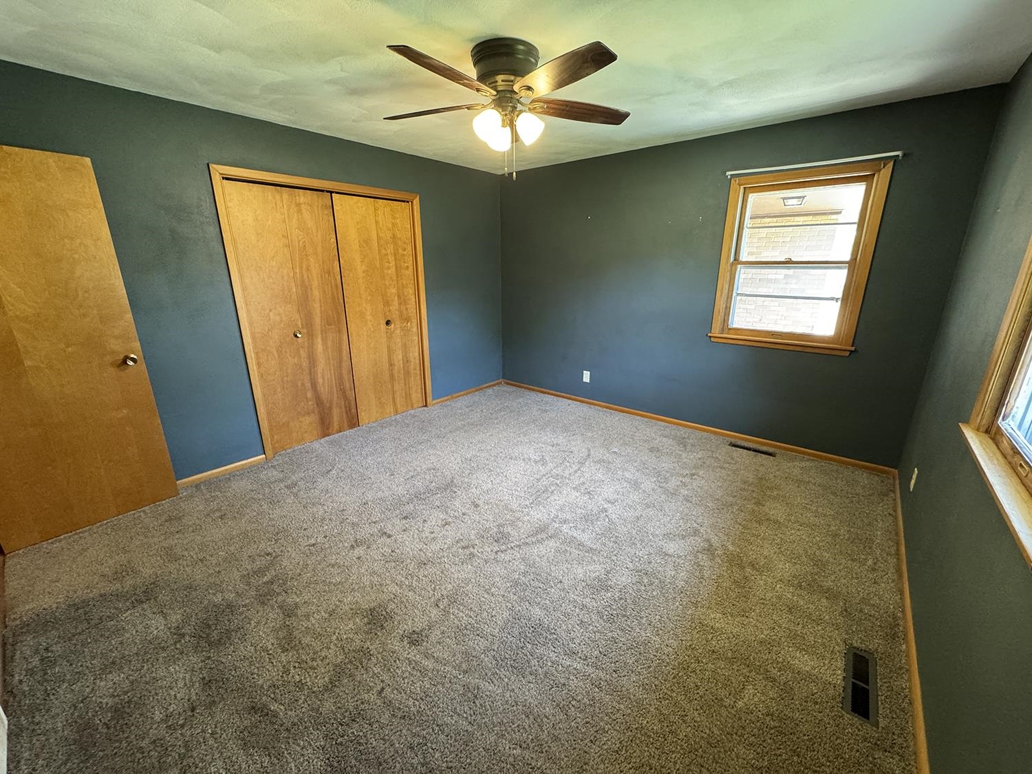 401 South Ridge Street Shannon, IL 61078 - Photo 23 of 40 a view of a room with a ceiling fan and a window