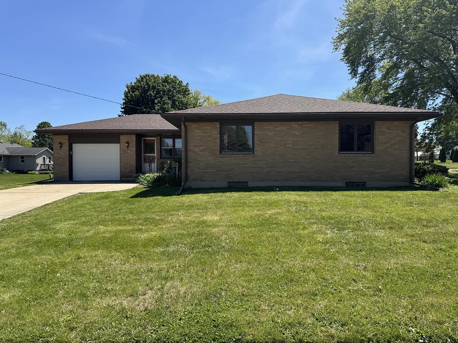 401 South Ridge Street Shannon, IL 61078 - Photo 4 of 40 a front view of house with yard and trees in the background