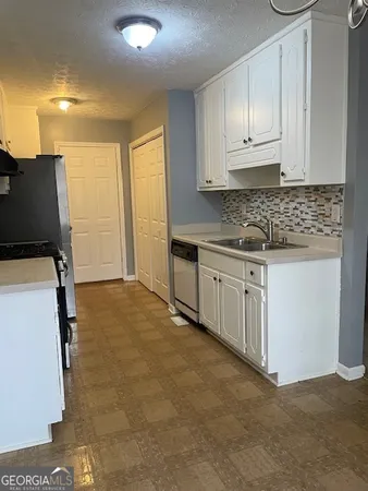 a view of a kitchen with electric appliances