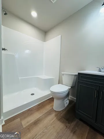 a bathroom with a toilet and a shower