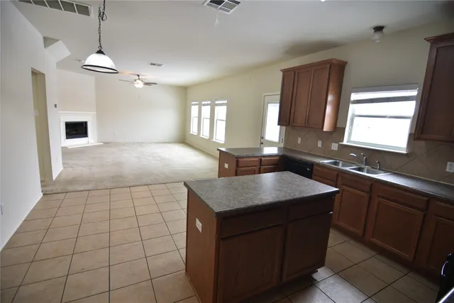 a kitchen with a sink a counter space and a window